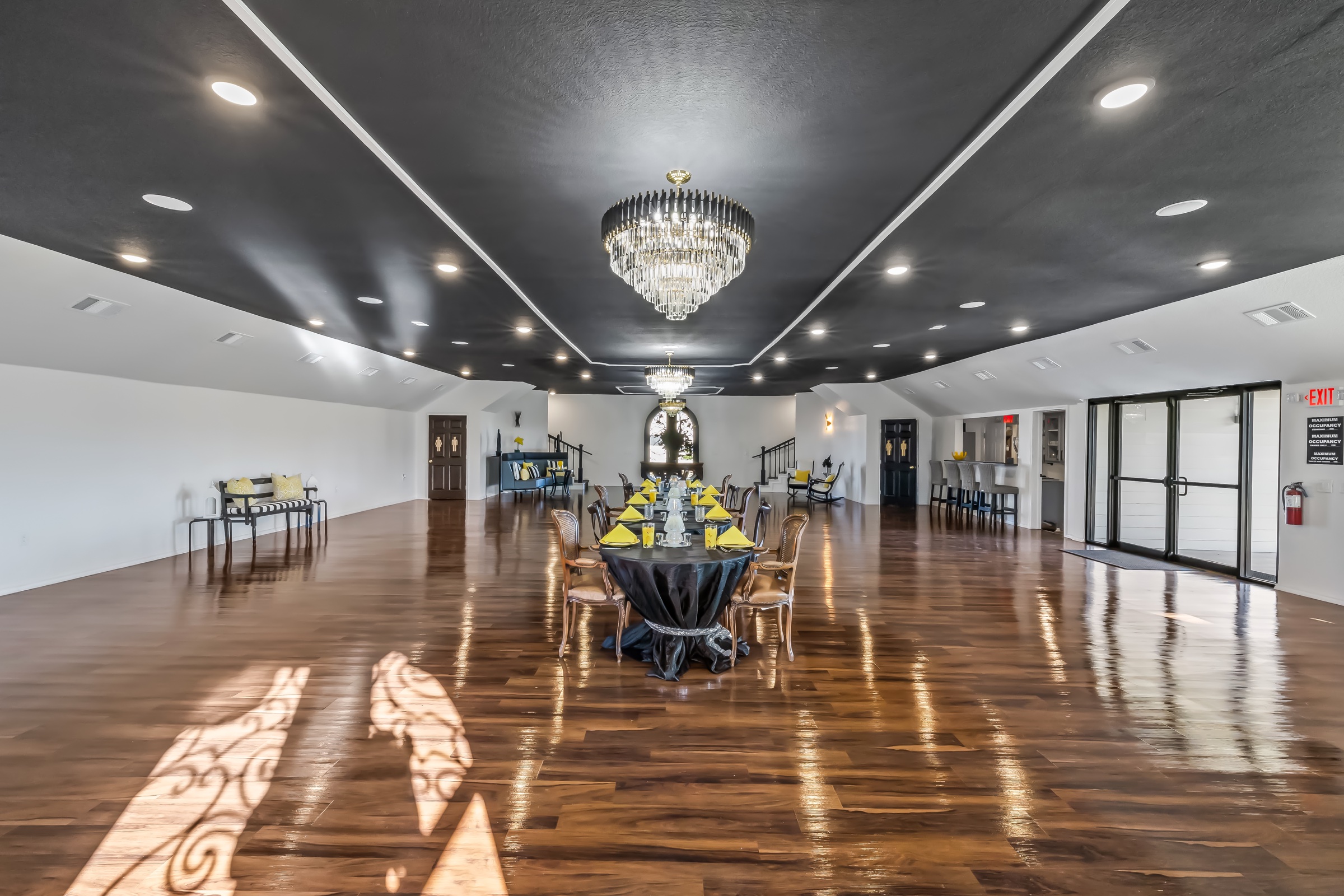 The ballroom glowing beneath crystal chandeliers.