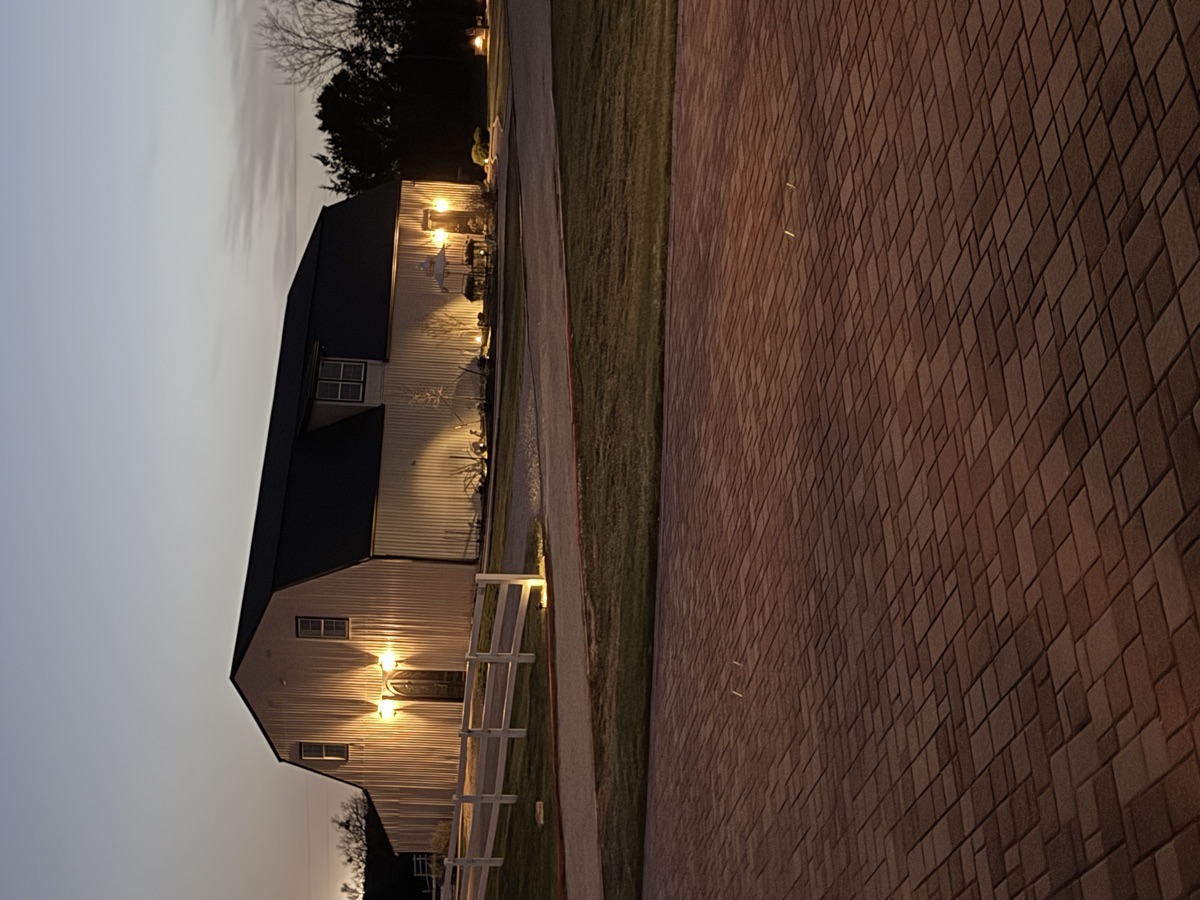 Twilight exterior with porch lights