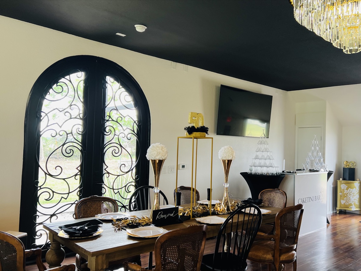 Venue interior with stained-glass arch and chandelier
